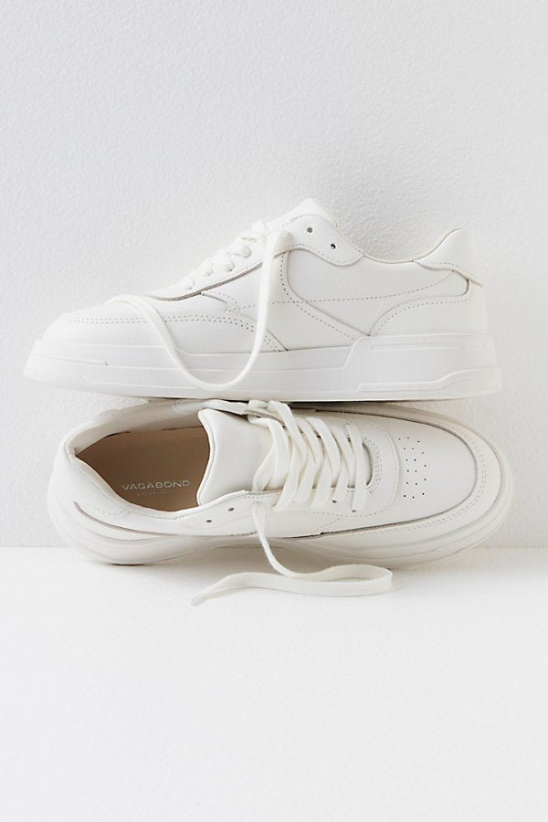 White leather low-top sneakers with lace-up closure and perforated details, displayed stacked against white background