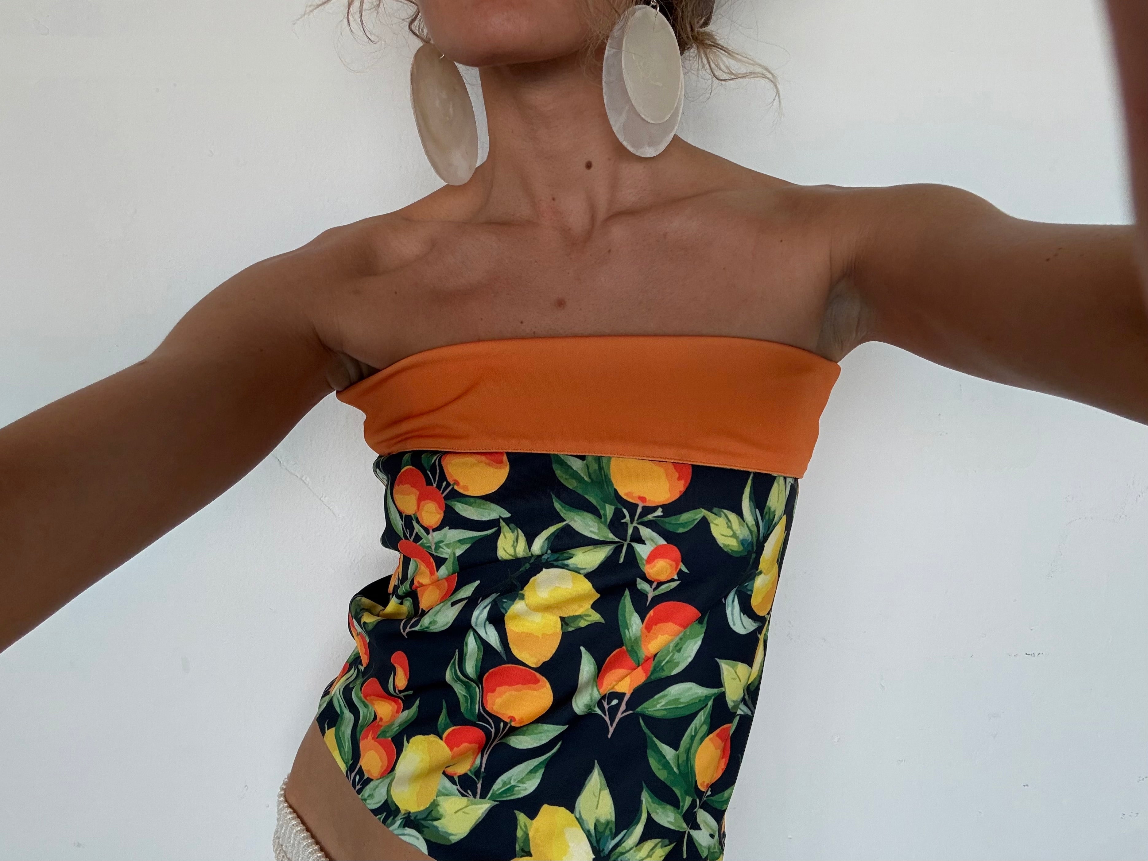 Orange and citrus print strapless bandeau top with color block design featuring lemons and oranges on navy background