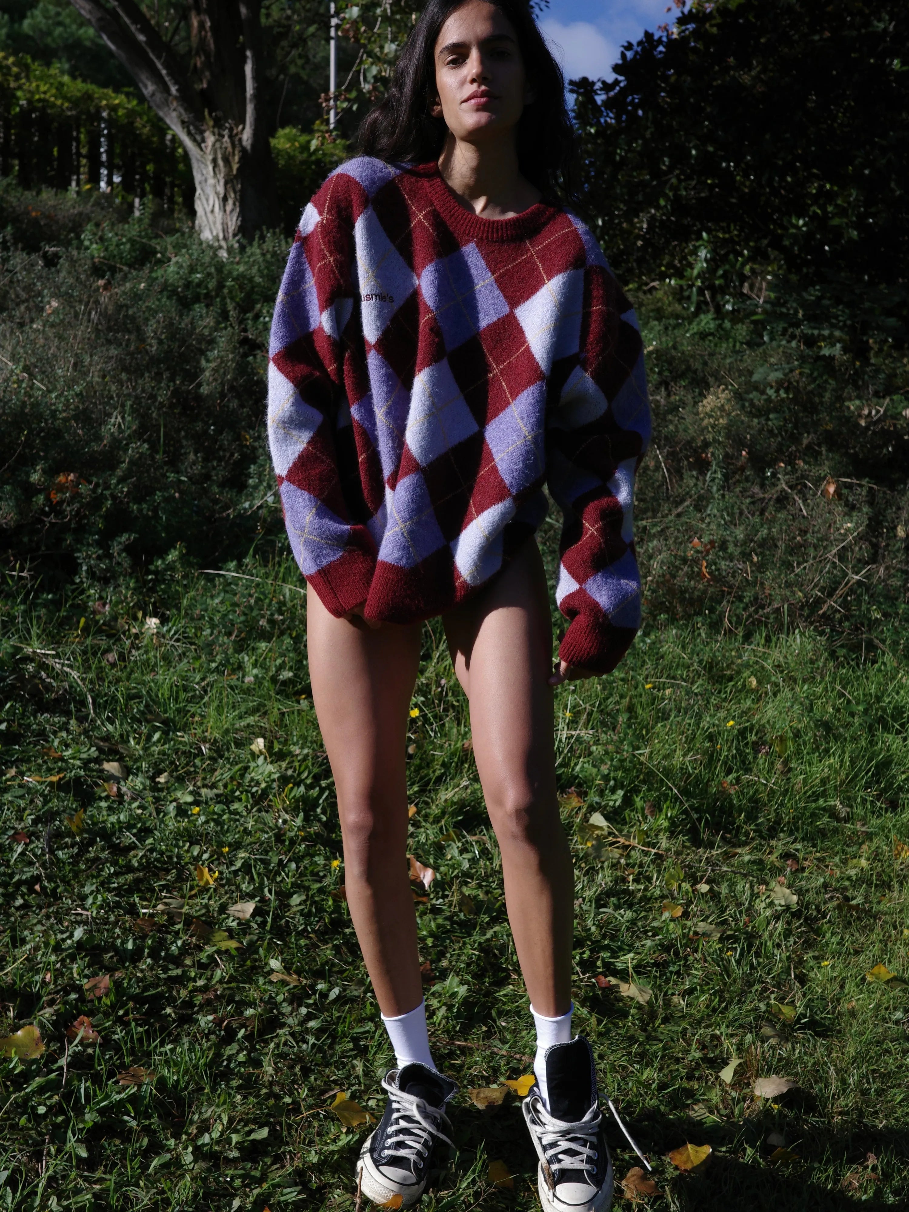 Oversized argyle knit sweater in burgundy, purple, and white with dropped shoulders and ribbed trim