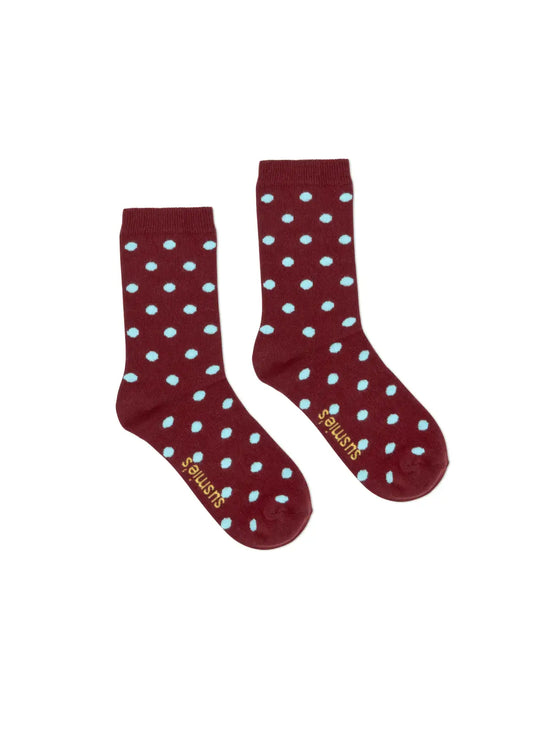 Burgundy red socks with light blue polka dot pattern, mid-calf length with ribbed cuffs