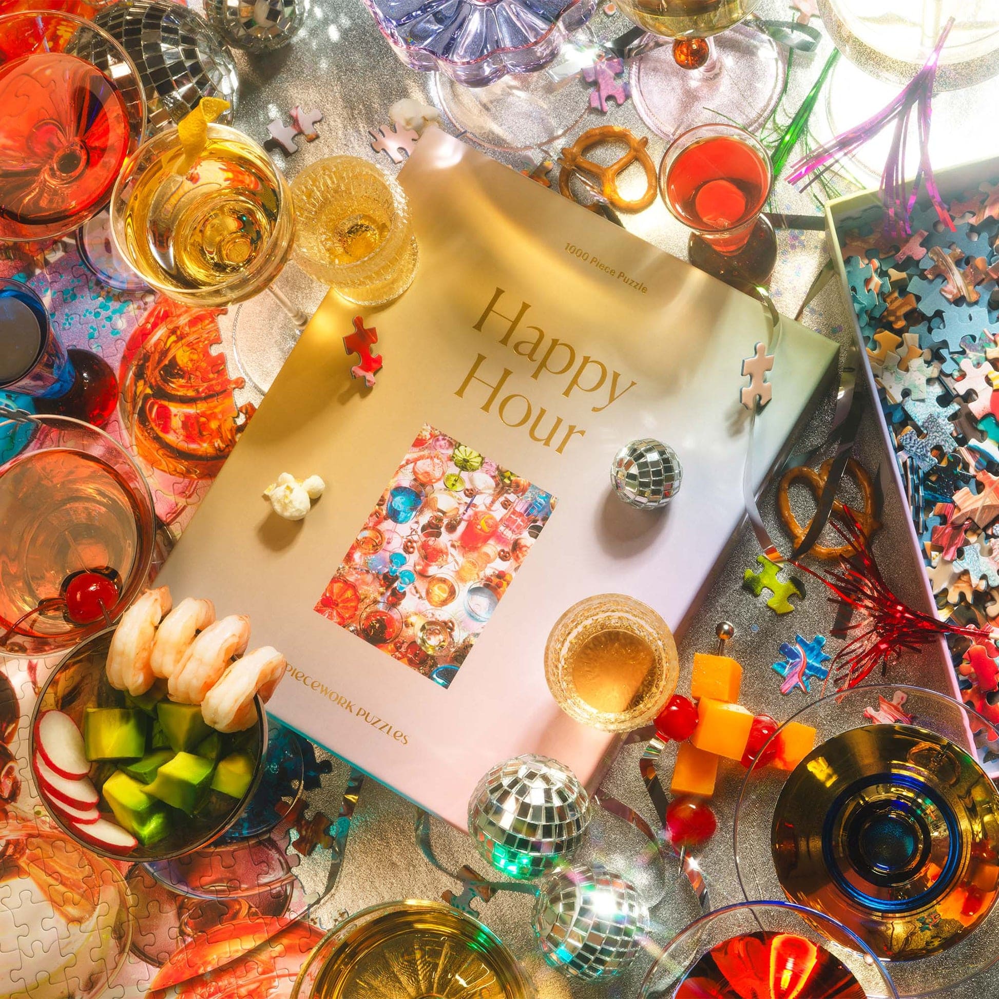 Festive Happy Hour puzzle box surrounded by colorful cocktails, disco balls, confetti, and party decorations on glittery surface
