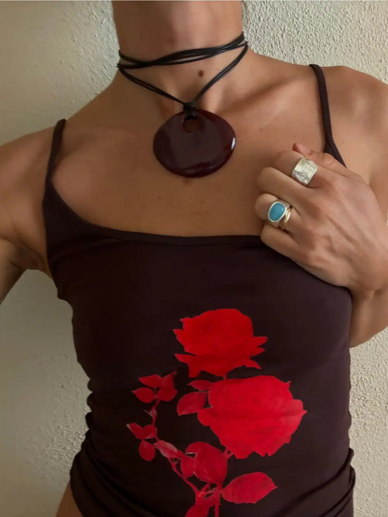 Brown spaghetti strap tank top with red rose print, styled with matching necklace and rings