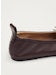 Dark brown leather slip-on shoe with pull tab, side view on white background
