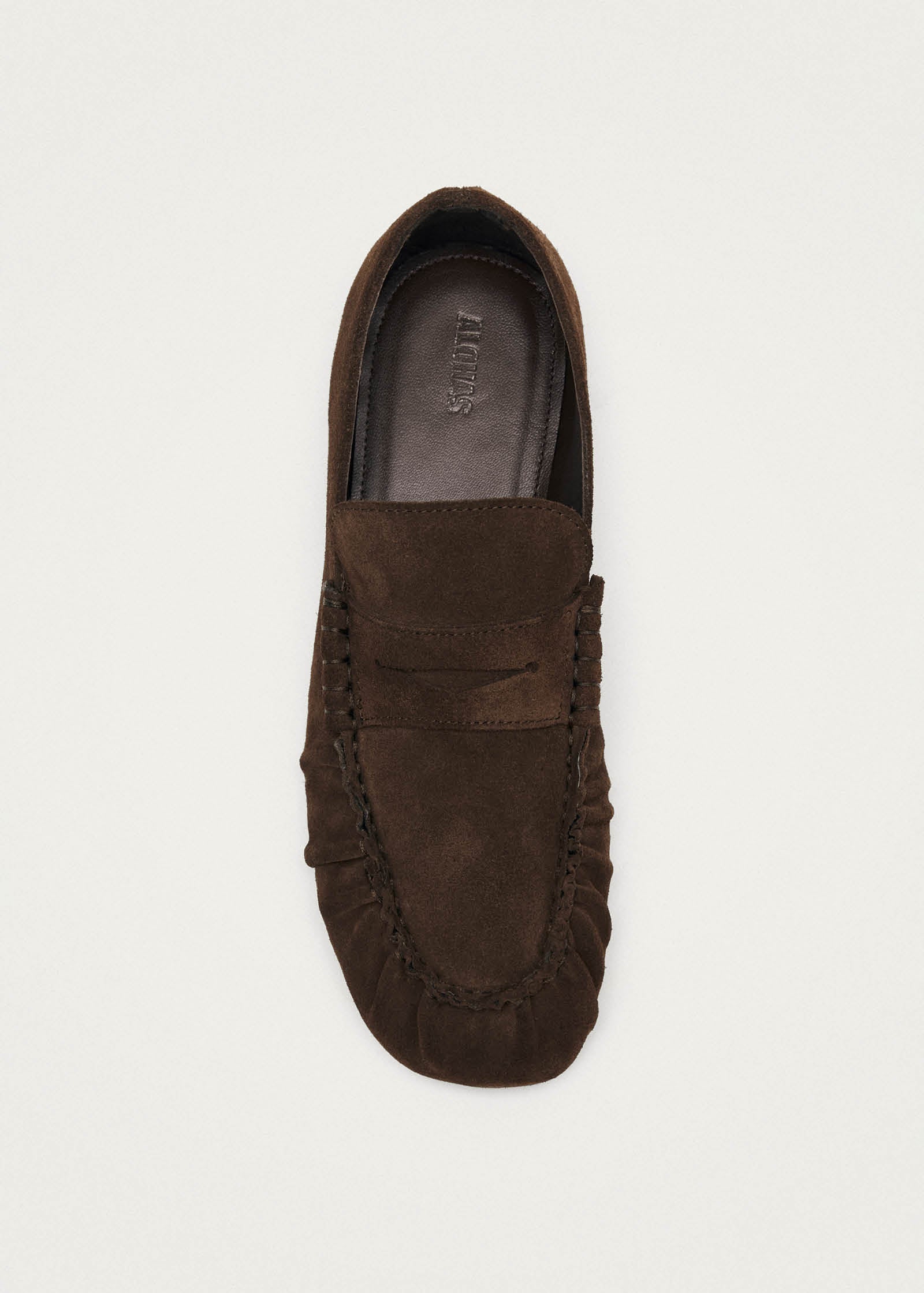 Brown suede penny loafer driving shoe with moccasin stitching and branded insole, viewed from above