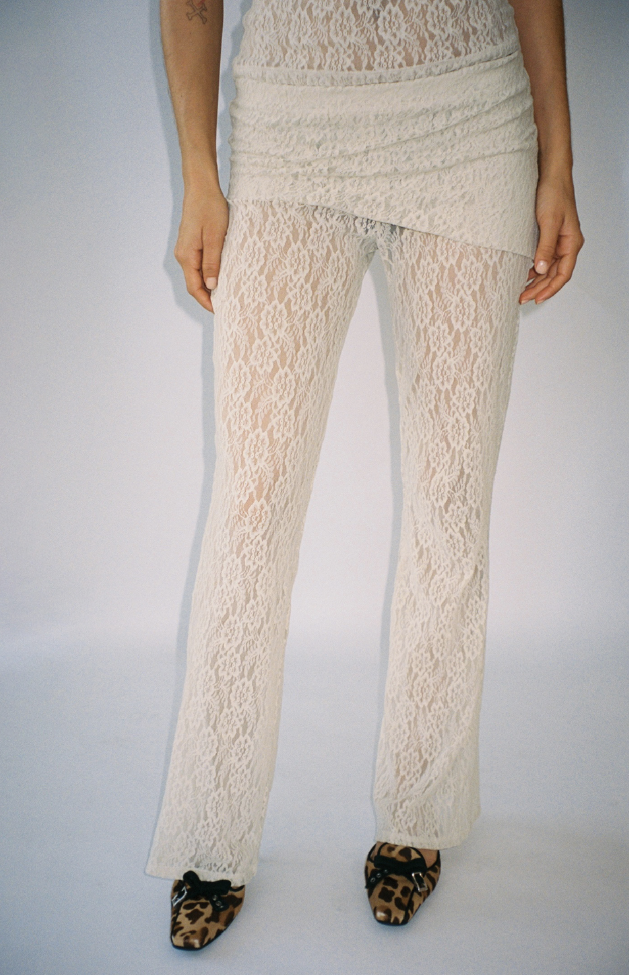 Cream lace flared pants with matching wrap-style top and leopard print flats