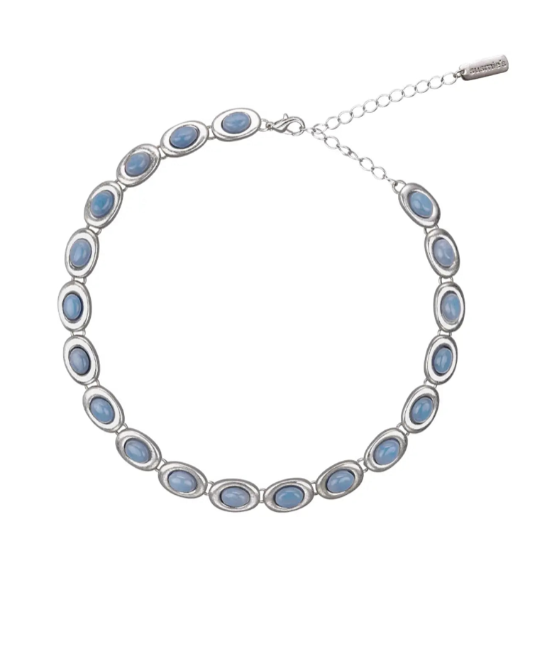 Silver-tone necklace with oval blue cabochon stones in bezel settings and adjustable chain extender