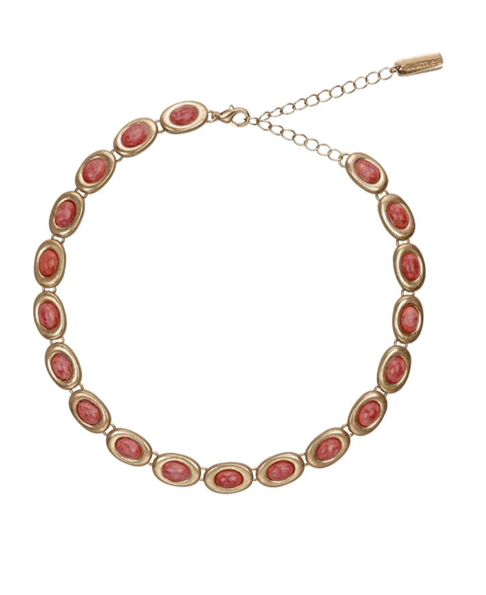 Gold-tone necklace with oval pink coral stones set in bezel frames with adjustable chain clasp