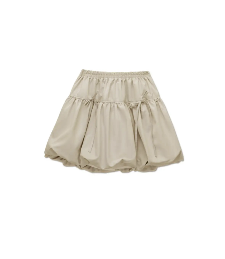 Light beige gathered bubble skirt with elastic waistband and tie detail, made from lightweight fabric with a voluminous silhouette