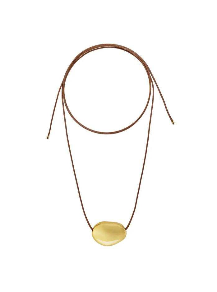 Minimalist necklace with yellow amber stone pendant on brown leather cord with adjustable sliding knot closure