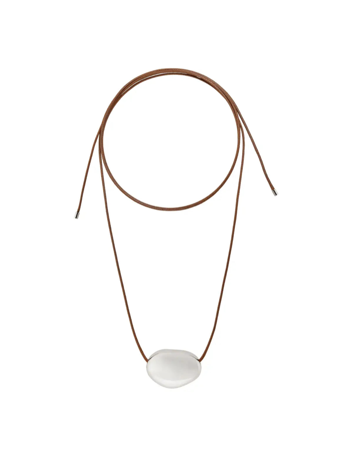 Brown leather cord necklace with smooth white oval stone pendant, adjustable sliding closure