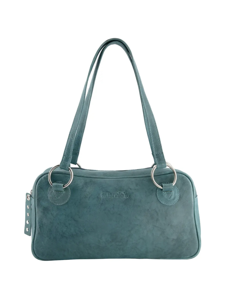 Teal blue suede shoulder bag with dual straps, metal ring details, and side studs by Suenos brand