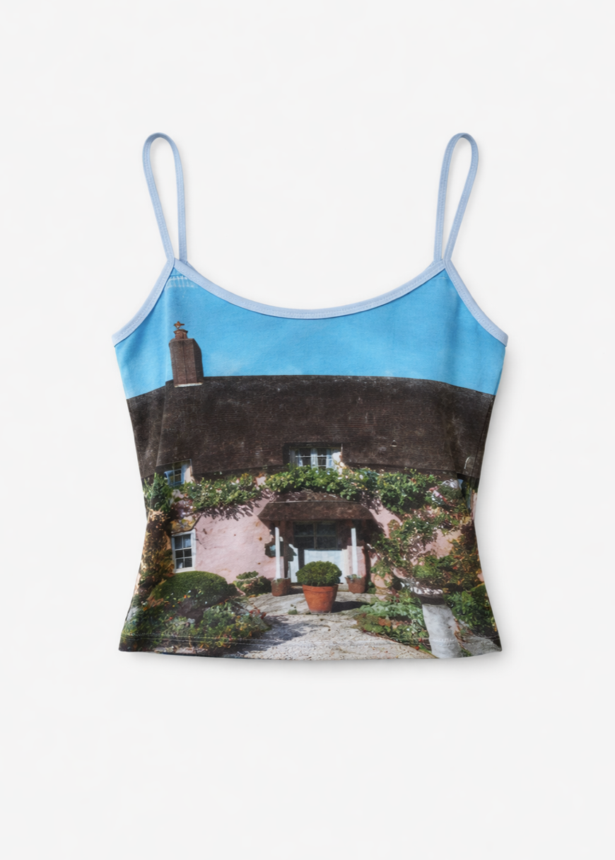 Light blue camisole tank top with photographic print of pink cottage with thatched roof and garden pathway