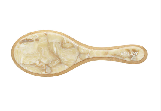 Wooden spoon filled with shredded coconut flakes on white background