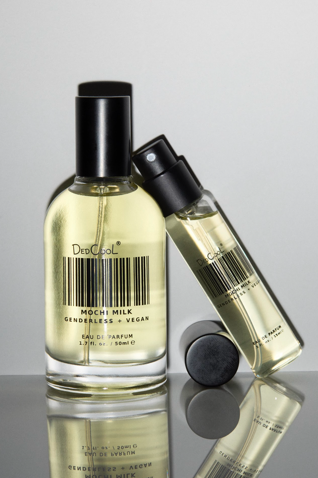 Light yellow perfume bottles with black caps displaying barcode label and "Mochi Milk" text, genderless vegan eau de parfum