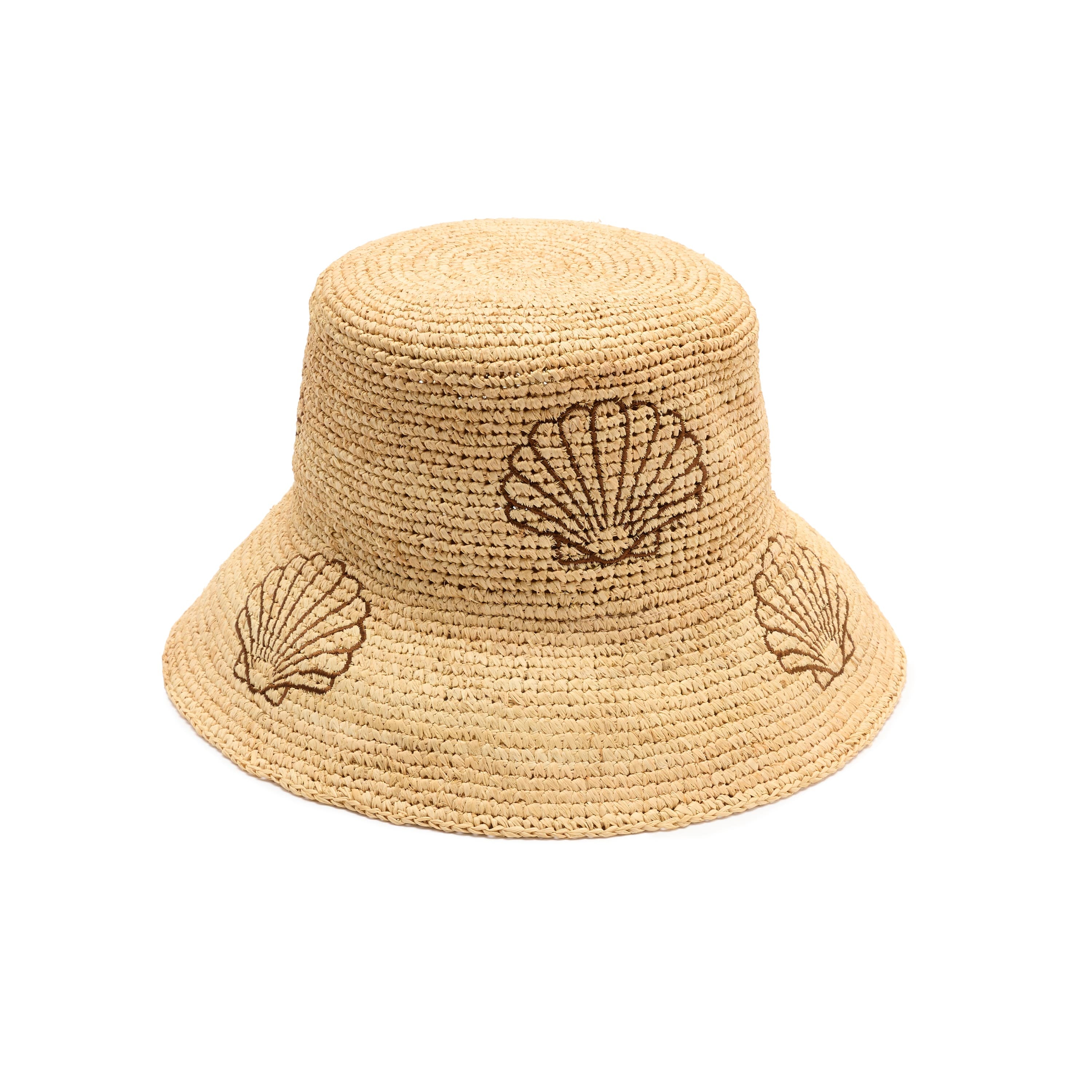 Beige straw bucket hat with shell designs on a white background
