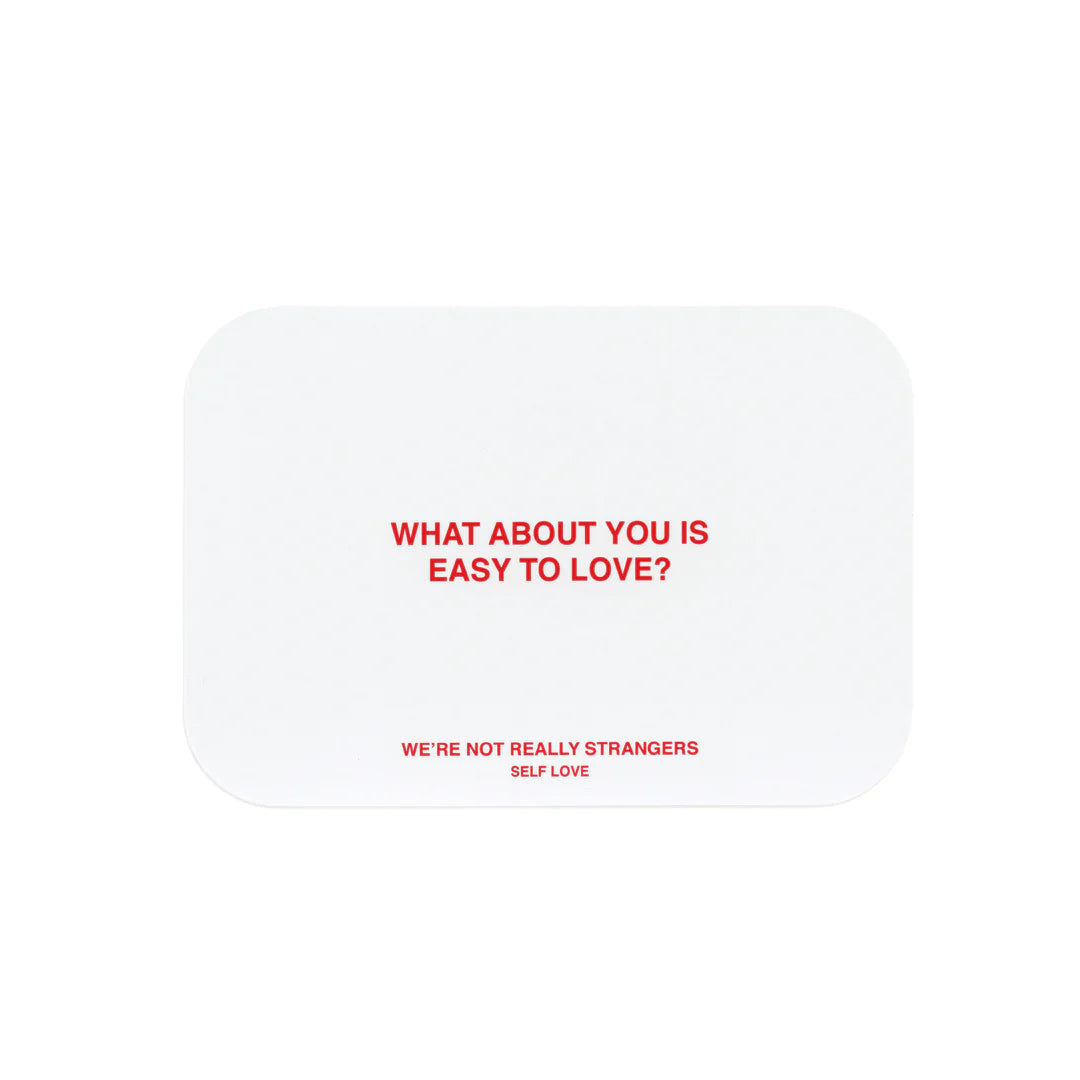 White rounded square card with red text reading "What About You Is Easy To Love?" and "We're Not Really Strangers Self Love"