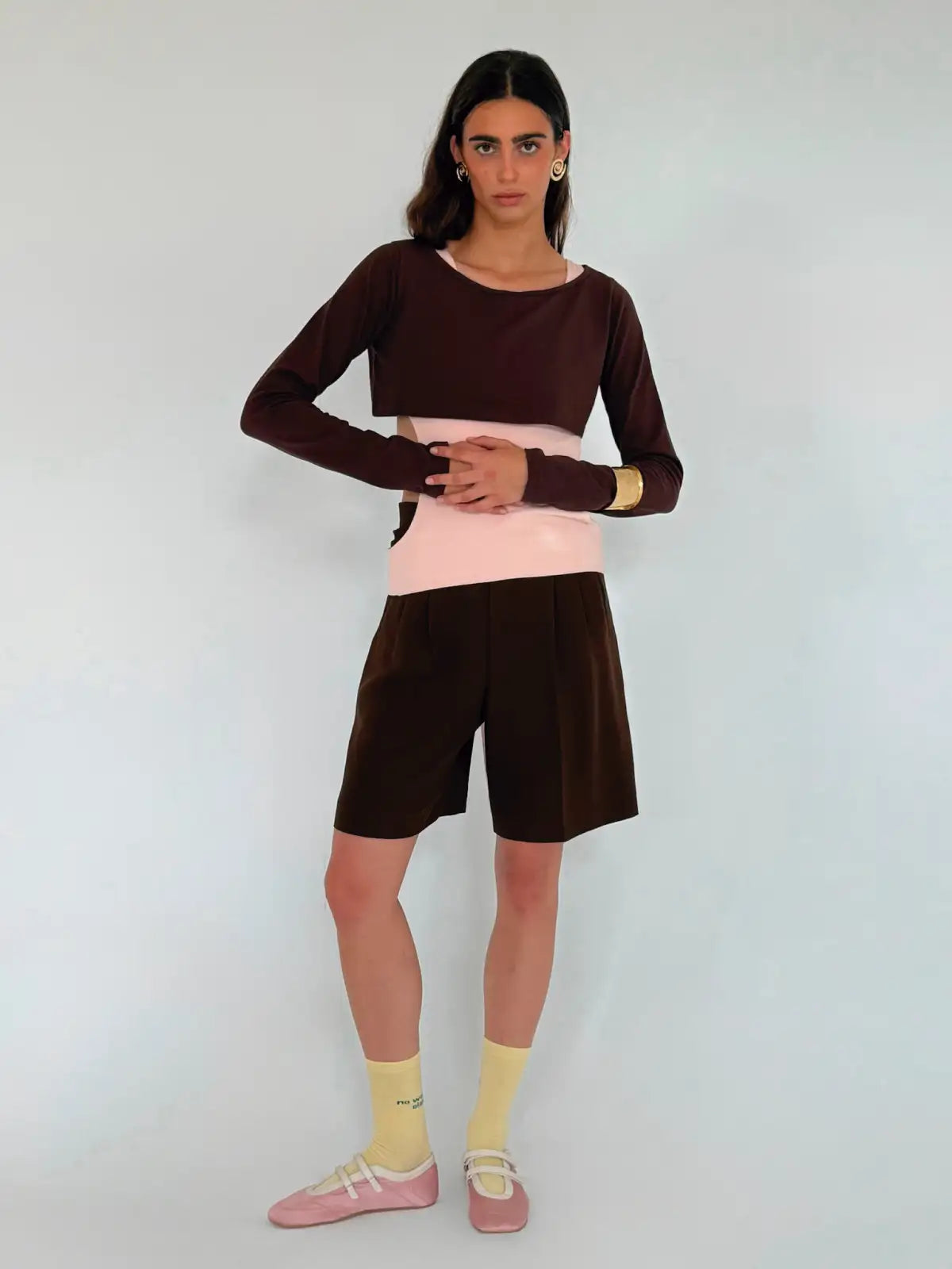 Color-block long sleeve top in brown and pink with matching brown shorts outfit, styled with yellow socks and pink shoes