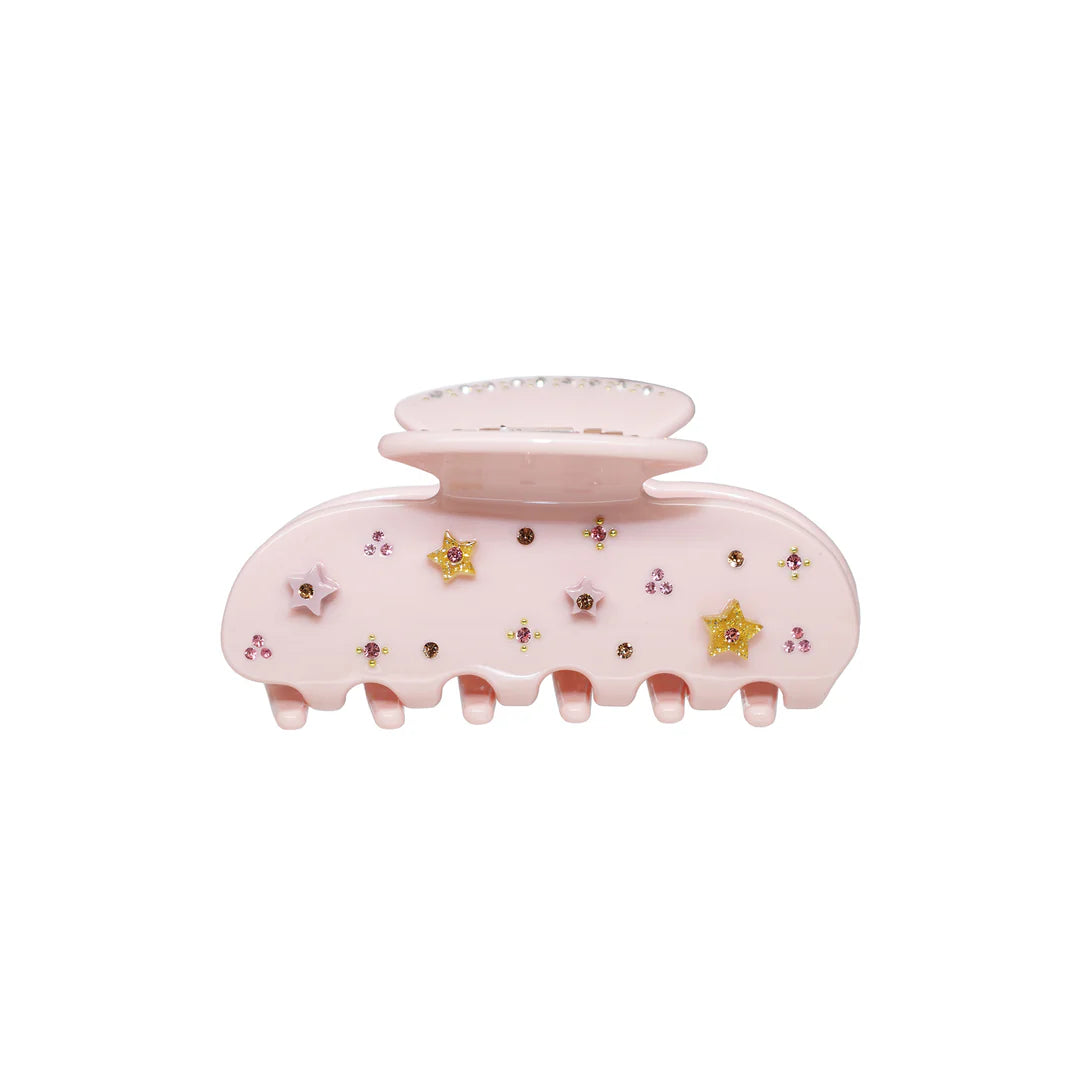 Pink hair clip with decorative elements on a white background