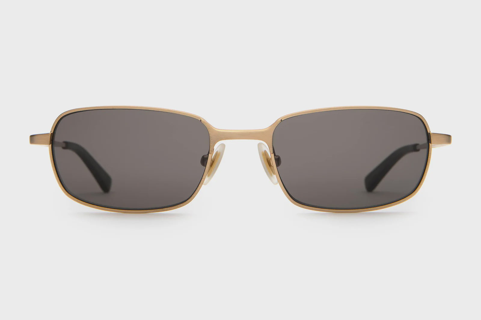 Gold-framed sunglasses with dark lenses on a white background