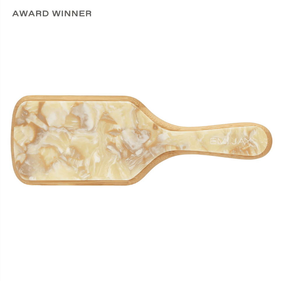 Award-winning paddle hairbrush in cream and tan marbled resin with bamboo trim and EMI JAY branding on handle