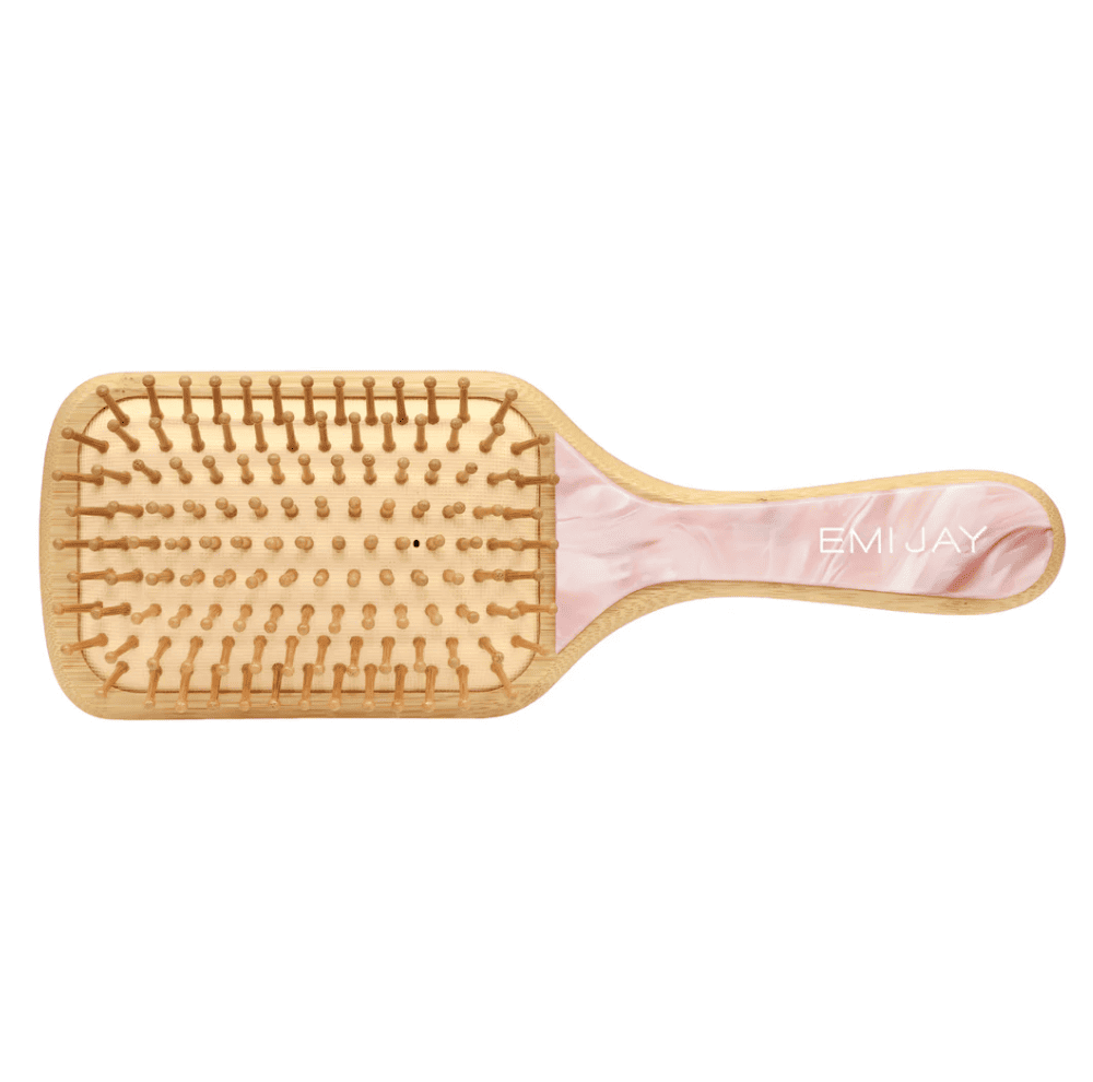 Wooden paddle hairbrush with bamboo bristles and pink marbled handle featuring EMI JAY branding