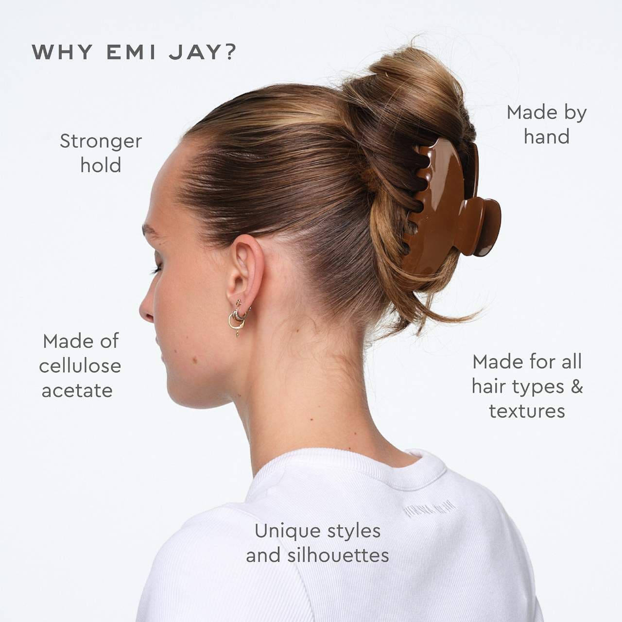 Brown tortoiseshell hair claw clip holding hair in an updo bun, made of cellulose acetate with unique curved design