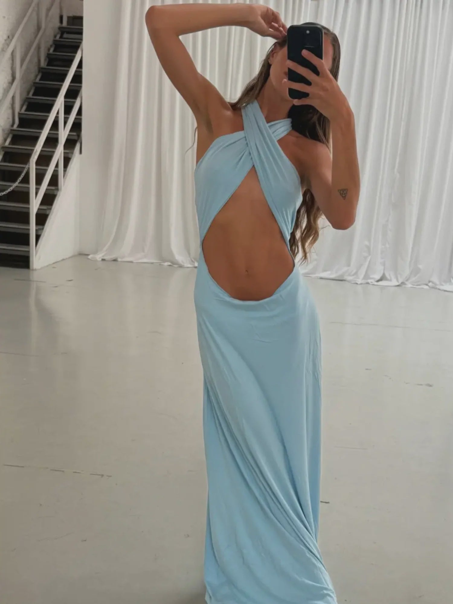 Light blue cross-front cutout maxi dress with halter neckline and floor-length silhouette in soft stretchy fabric