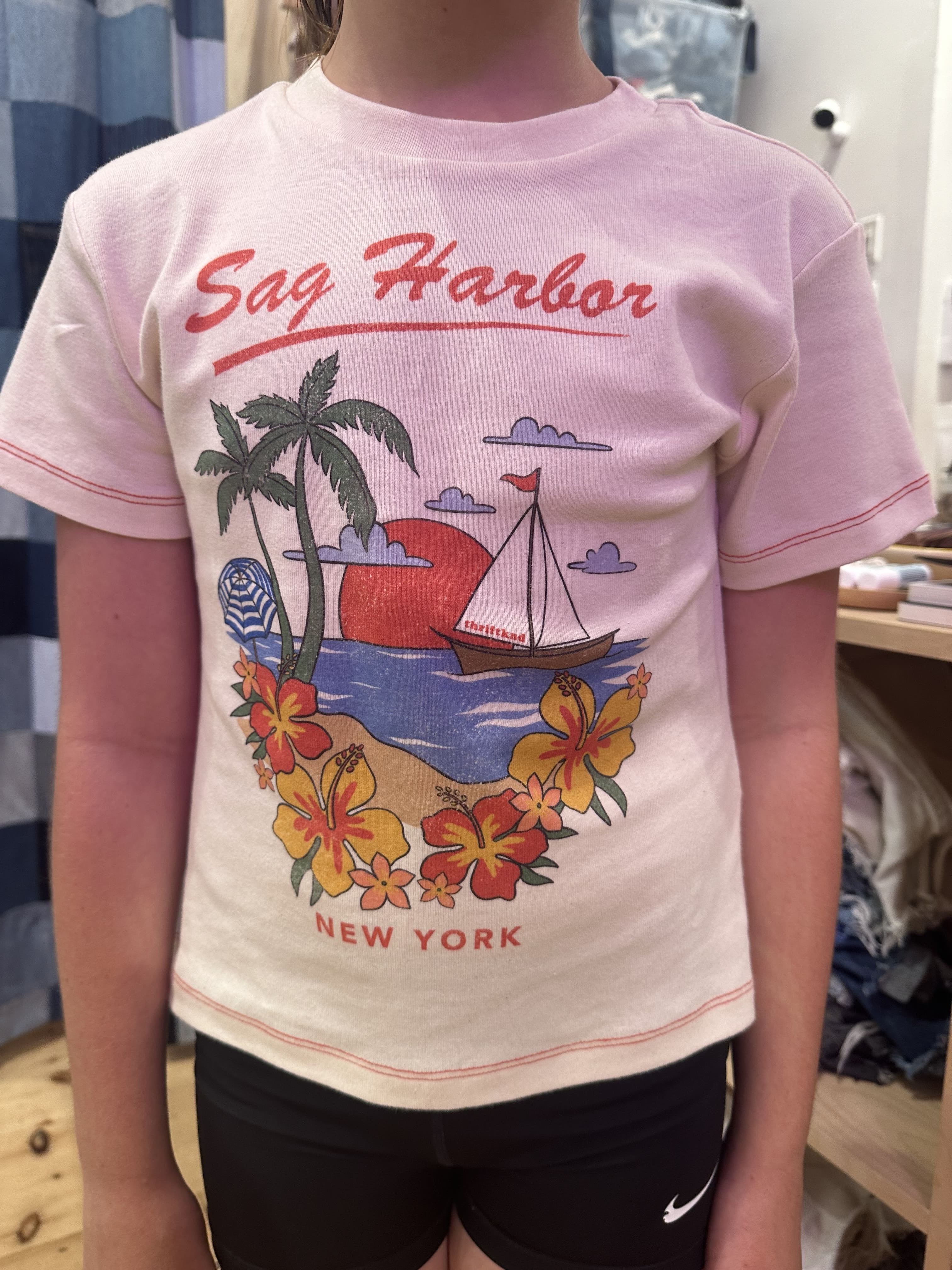 Person wearing a sleeveless top with 'Sag Harbor New York' design