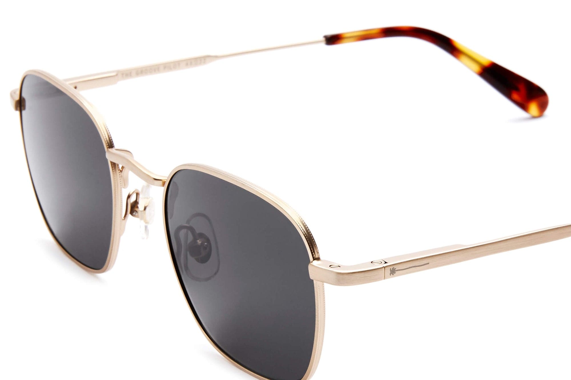 Gold metal frame sunglasses with dark grey lenses and tortoiseshell temple tips in a classic square aviator style