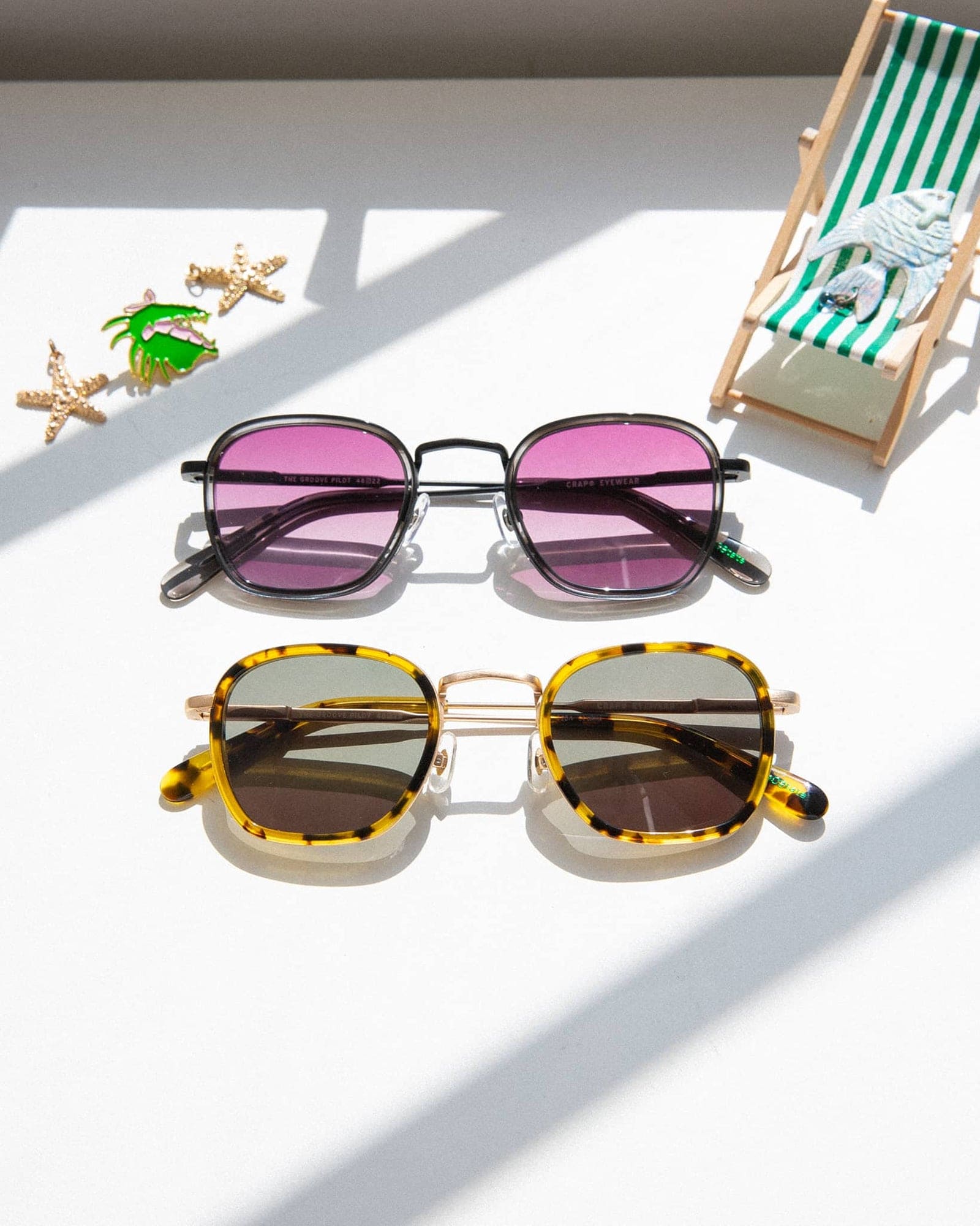 Two pairs of square-frame sunglasses with metal bridges - one with black frames and pink lenses, one with tortoiseshell frames and brown lenses