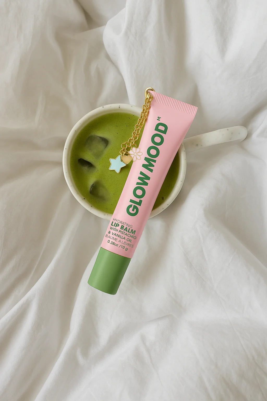 Lip balm with 'Glow Mood' branding on a white fabric background