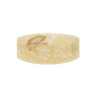 Oval-shaped pale yellow resin soap dish with embedded dried flowers and translucent finish