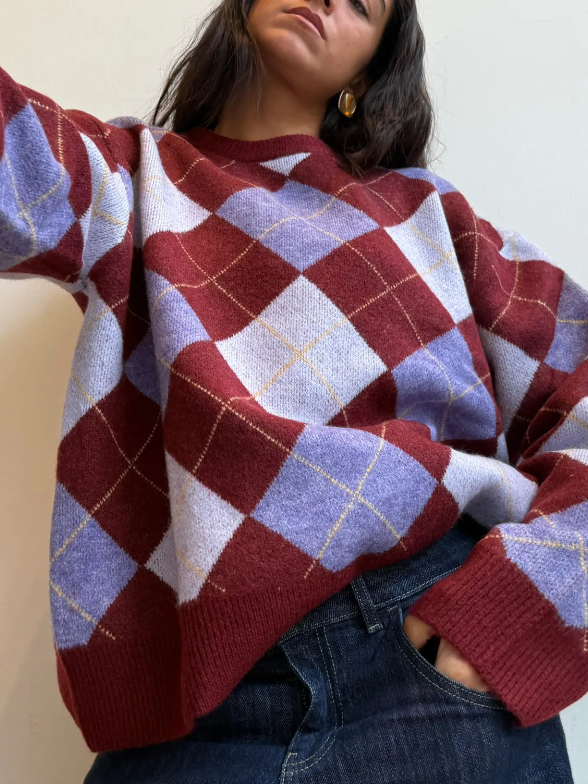 Burgundy and lavender argyle knit sweater with yellow accent lines, worn with blue jeans