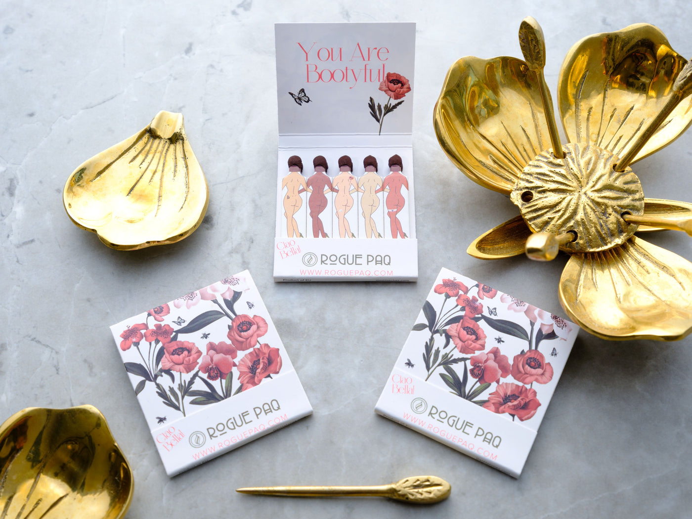 Body positive greeting cards with pink floral designs and gold decorative dishes on marble background
