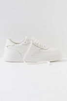 White leather platform sneaker with lace-up closure and chunky sole, side view on white background