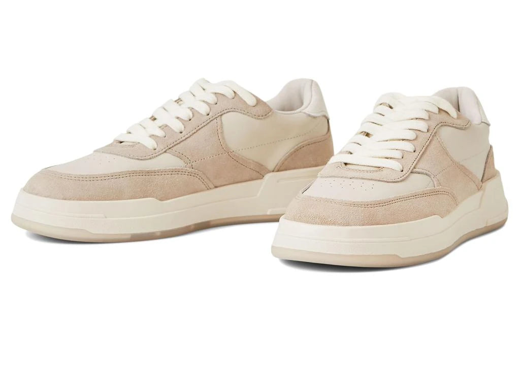 Pair of beige sneakers on a white background