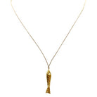 Gold fish pendant necklace on delicate chain with textured scale details and dimensional design