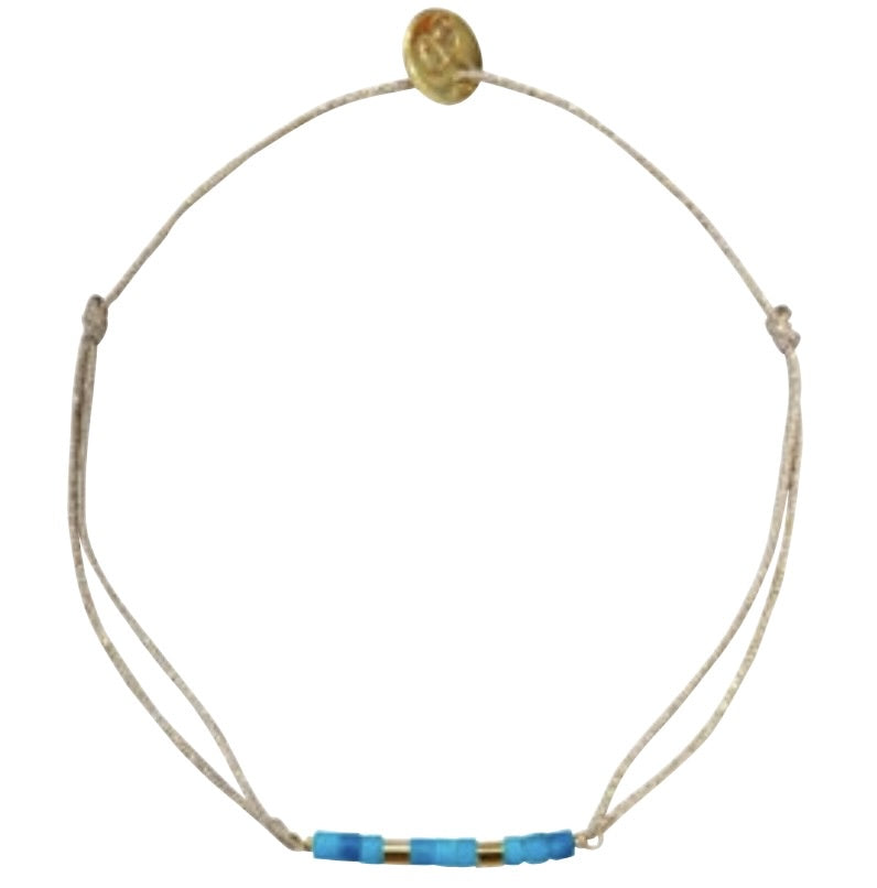 Adjustable beige cord bracelet with blue and gold beads and gold coin charm at top