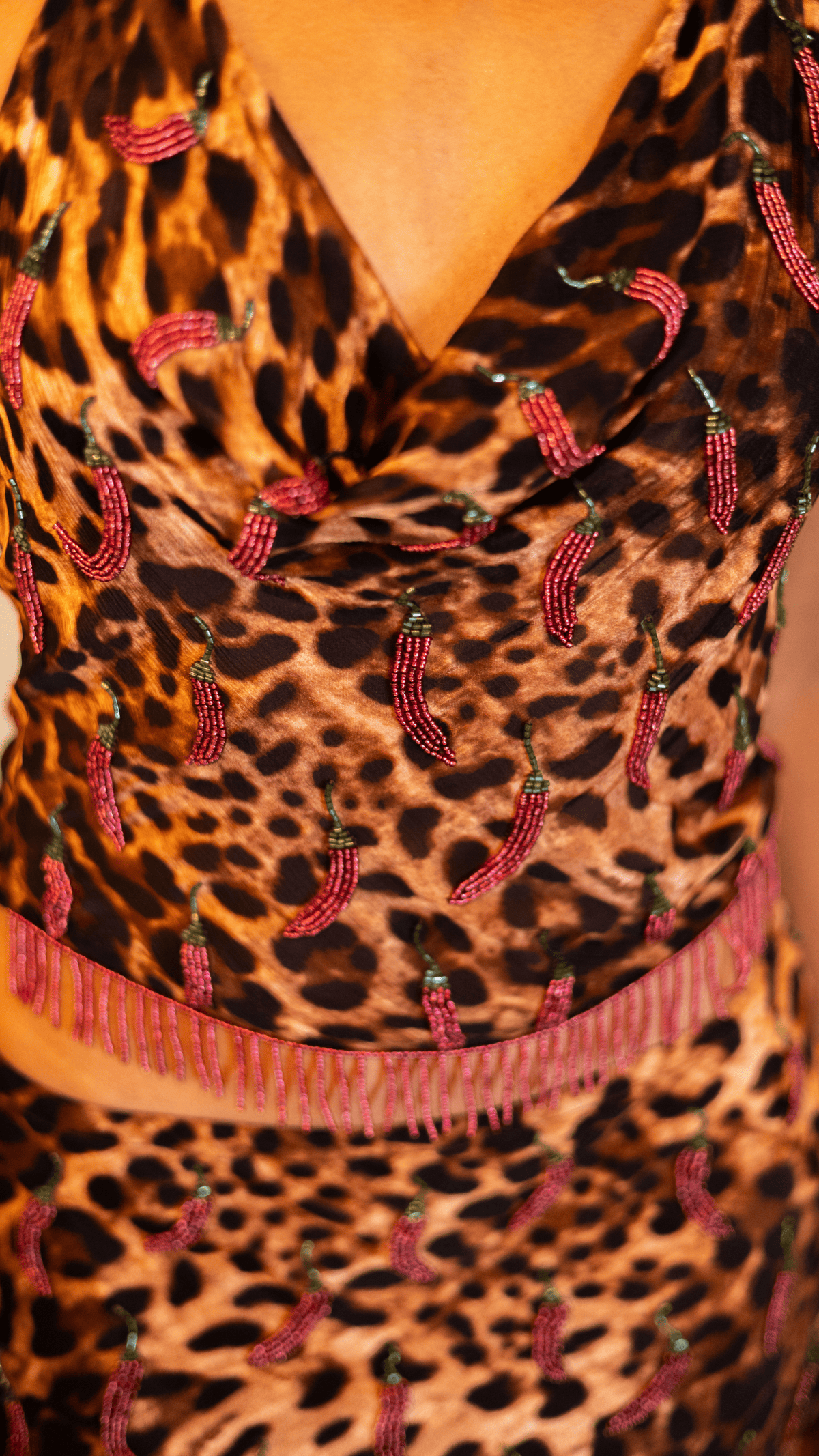 Leopard print dress with pink beaded embellishments and fringe belt detail