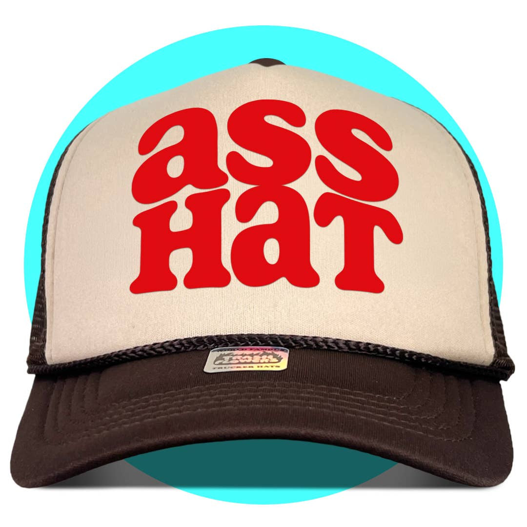 Brown and white mesh trucker hat with red "ass HaT" text on front panel against turquoise background