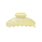 Yellow marble hair claw clip with textured surface and teeth grips for securing hair