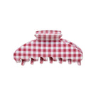 Red and white gingham check hair claw clip with ridged center grip and curved design