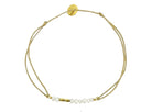 Delicate gold cord bracelet with white freshwater pearls and adjustable sliding closure