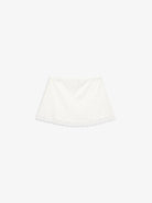 White lace-trimmed linen skirt with elastic waistband laid flat on light background