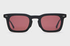 Black sunglasses with red lenses on a white background