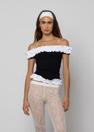 Black off-shoulder ruffle trim crop top with white ruffled neckline and hem detailing