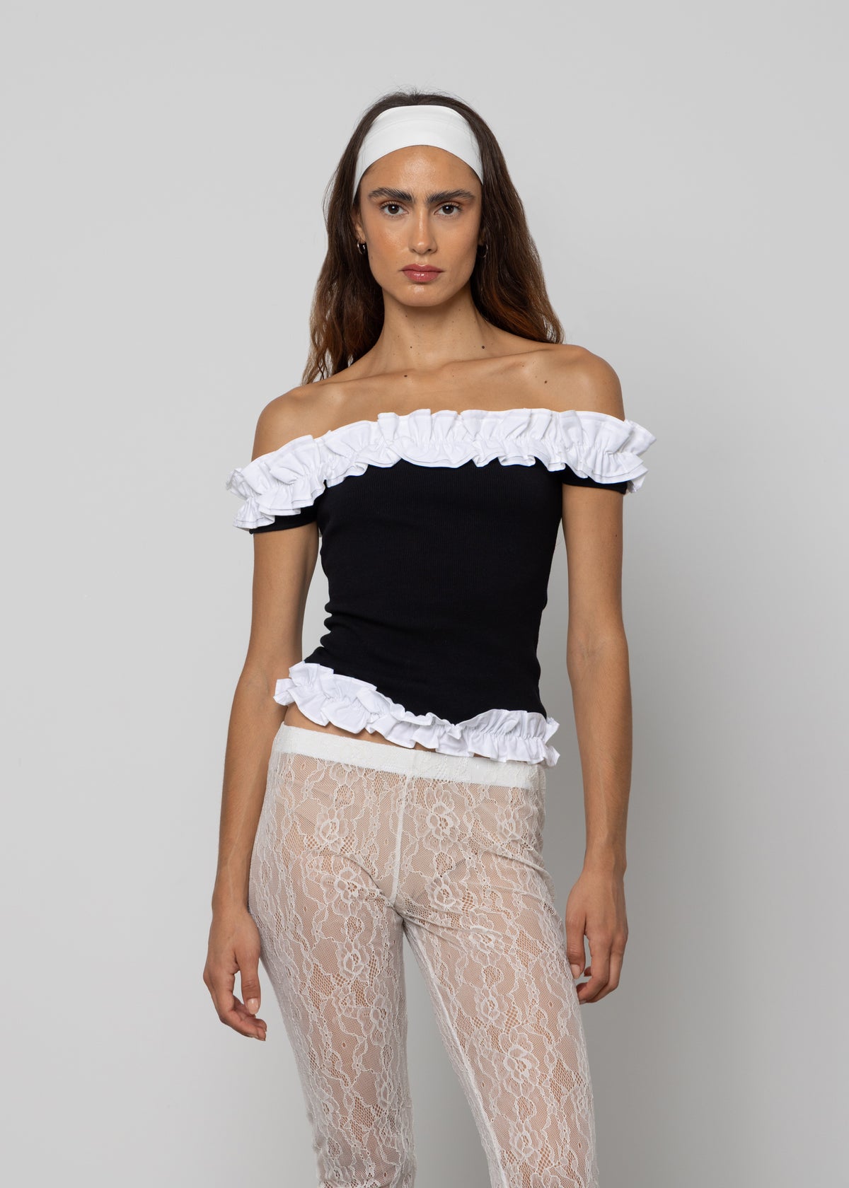 Black off-shoulder ruffle trim crop top with white ruffled neckline and hem detailing