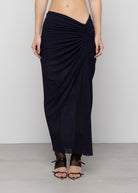 Black mesh maxi skirt with twisted draping detail at hip, semi-sheer fabric, asymmetric gathered design