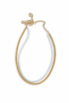 Necklace with gold and white beads on a white background