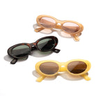 Three pairs of sunglasses in different colors on a white background